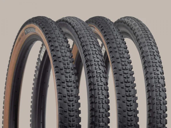 Teravail Ehline tires lined up against a tan background with tread detail shown