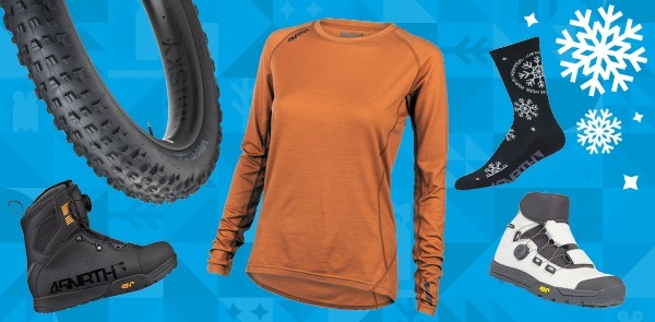 Several 45NRTH winter cycling products, such as tires, boots, and base layers, are arranged on a blue background.