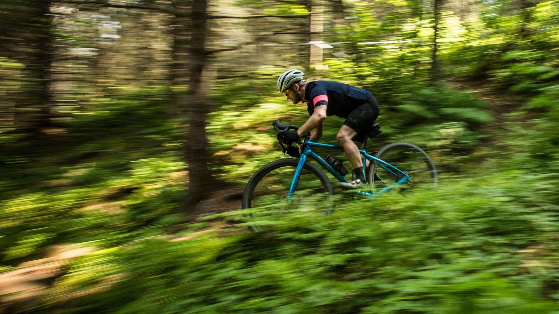 Gravel bike riding on an open road near mixed terrain
