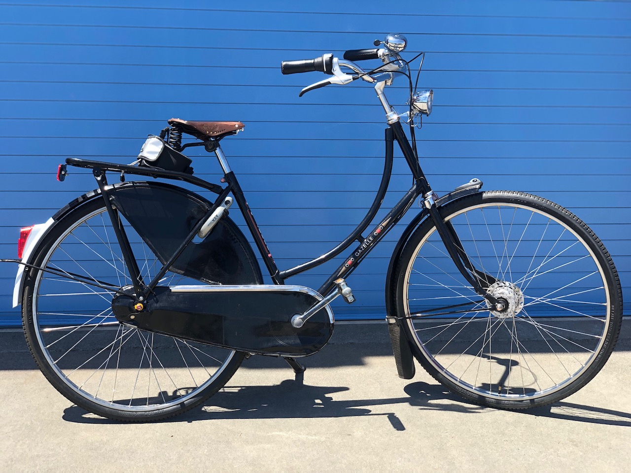 A black, Dutch Gazelle Populaire step thru comfort bike that offers upright seating position and comfortable handlebars. 