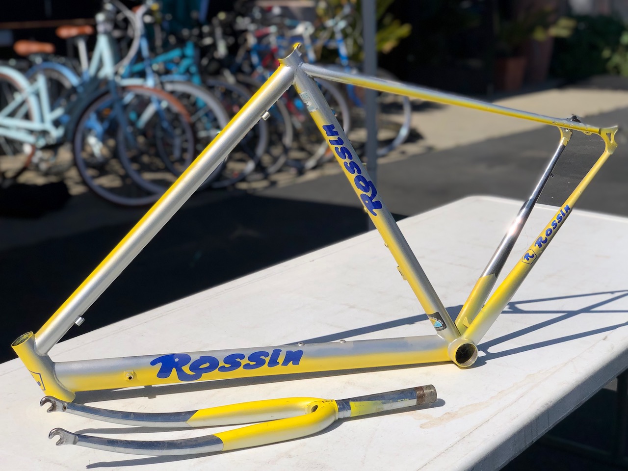 A silver and yellow Italian Rossin frame and fork with blue highlights are offered on consignment.