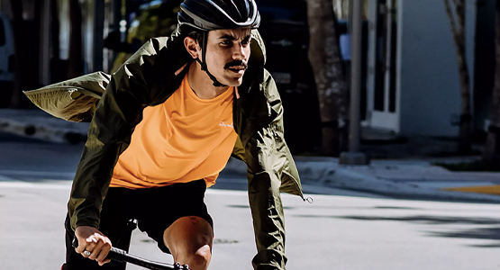 man riding city bike wearing rapha apparel