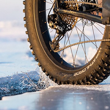 studded winter fat bike tire rolling on ice