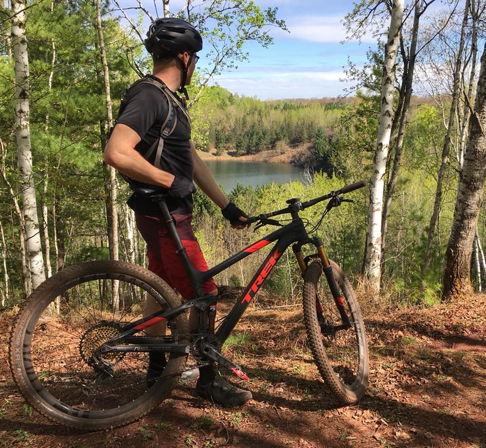 mountain biker looking out on lake