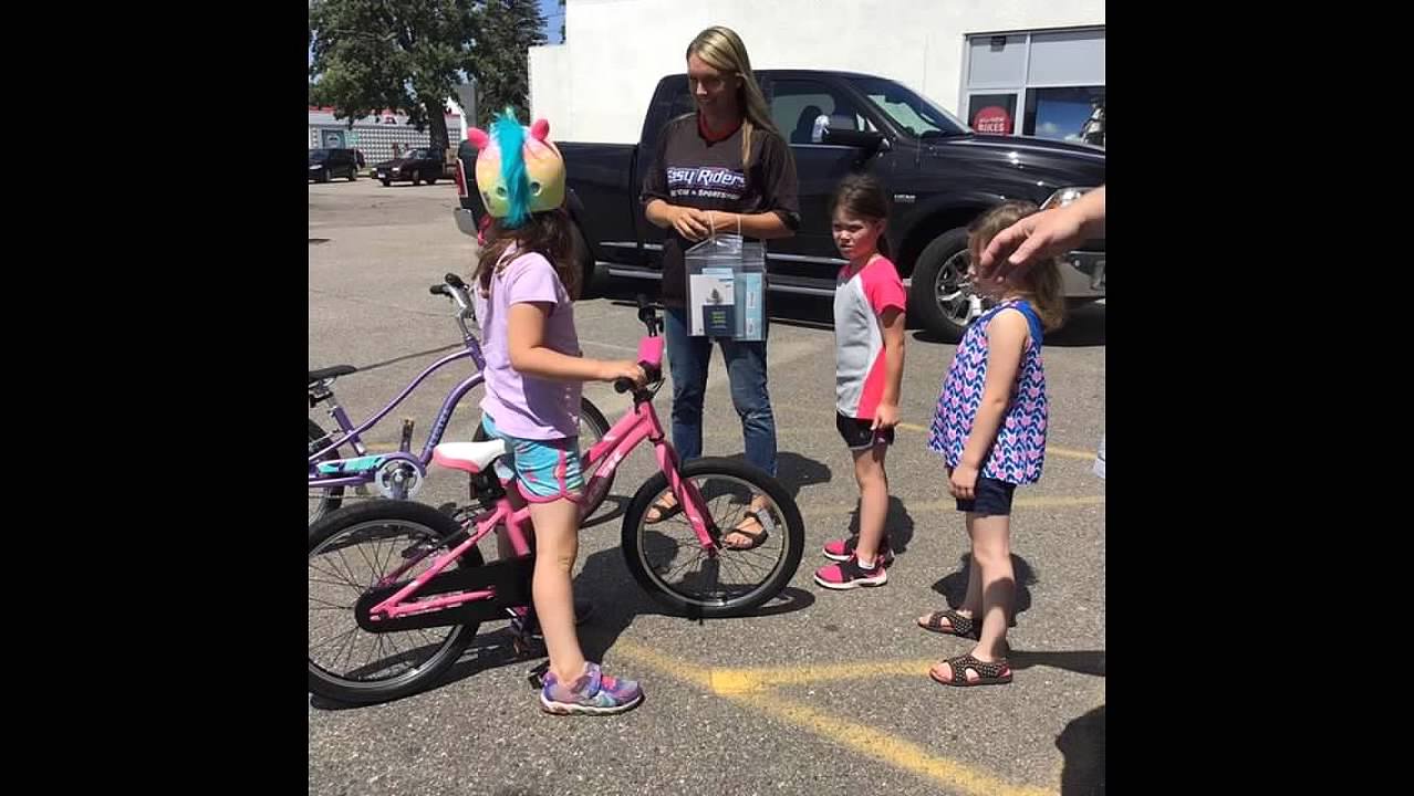 staff and kids with kids' bikes