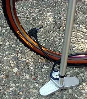 Attaching a bicycle pump to the tire