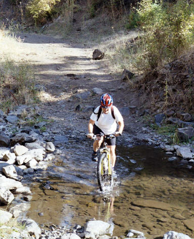 Carol Ellis, the world famous Nurse Practitioner does a water crossing on Mission Creek.